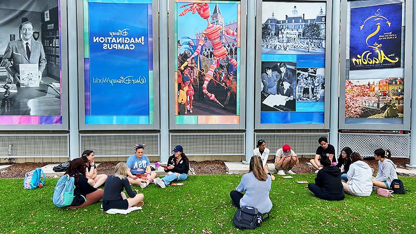 Image of students in groups outside of the Disney Imagination Campus. 